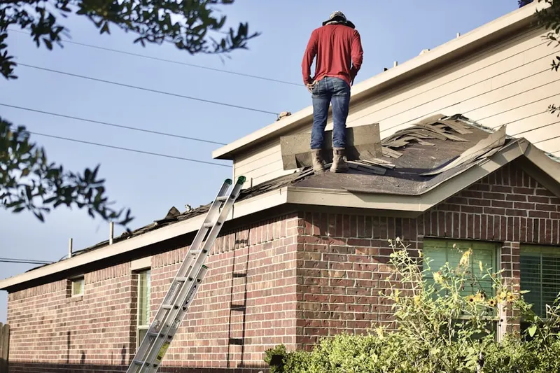 Professional roofer working on a residential roof in Rye Brook